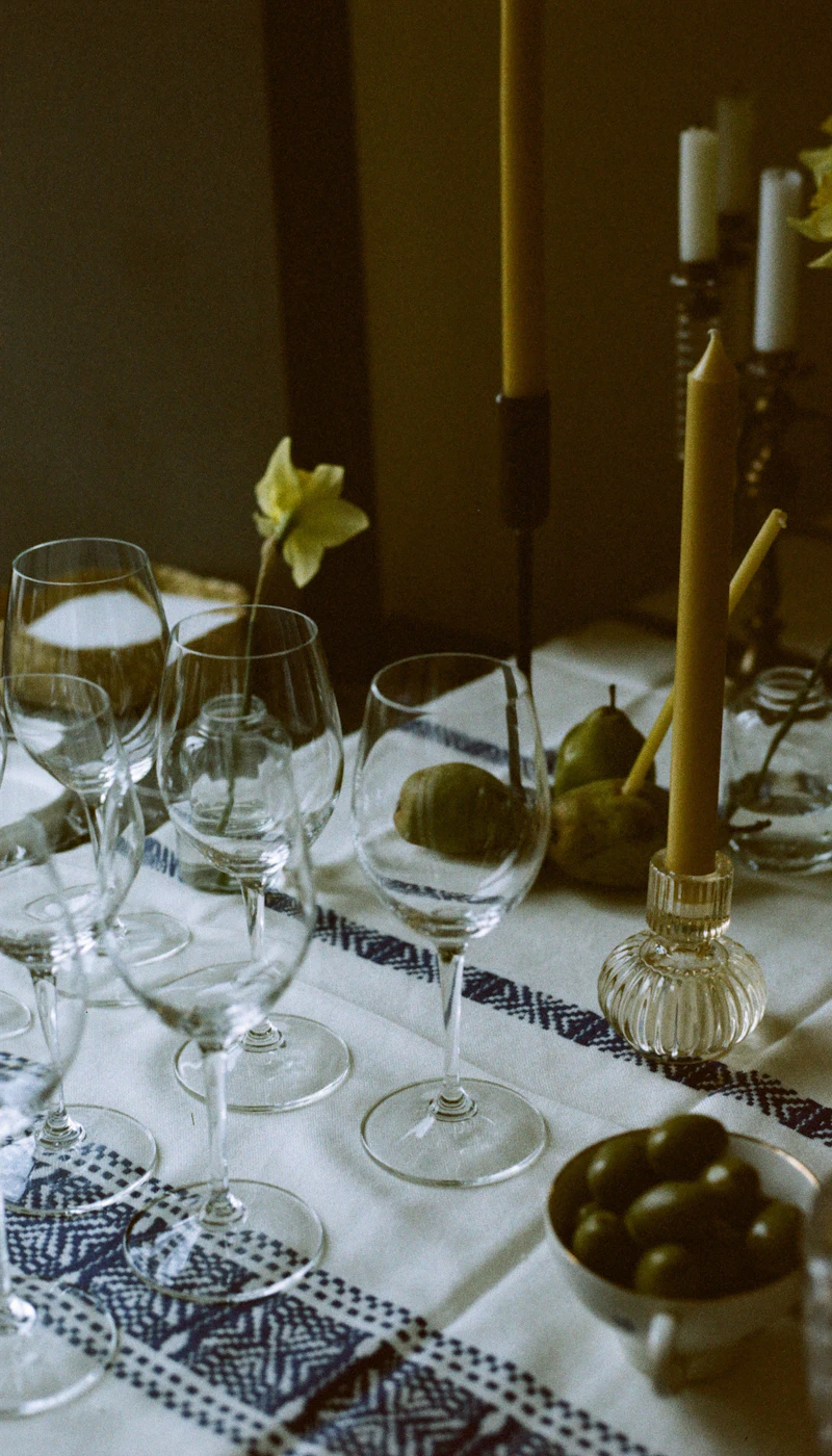 Wine glasses and candles on a set table
