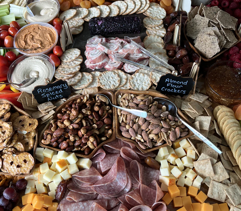 An abundant grazing spread of nuts, crackers, cheeses and cured meats